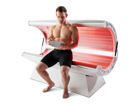Photo of man in a red light therapy bed